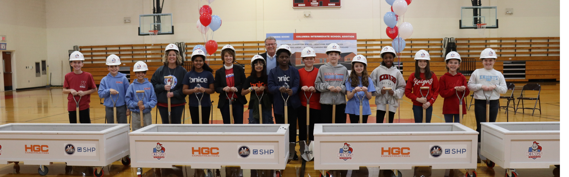 CIS Students pictured with Senator Steve Wilson at CIS Groundbreaking. Students wearing hard hats and holding shovels